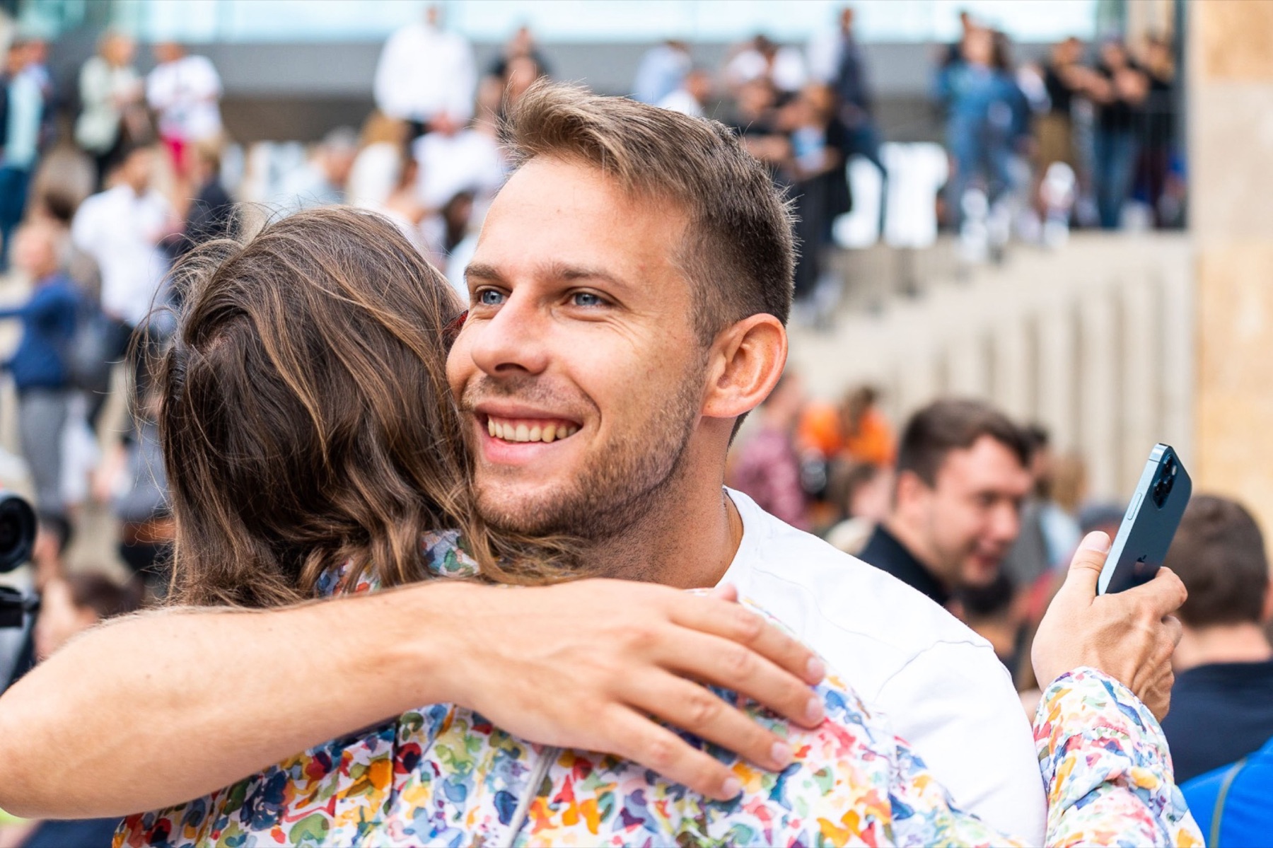 Thomas embracing a guest at a gathering