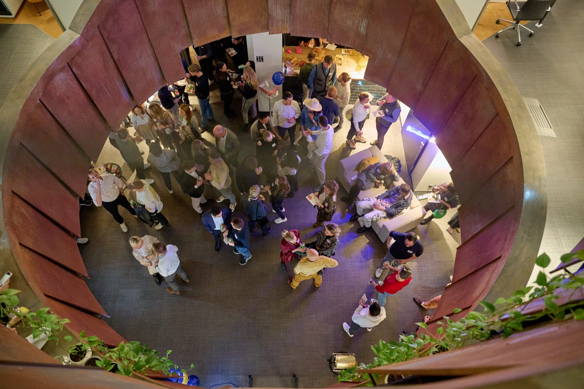 Guests getting to know each other in small groups at a BOBC gathering, viewed from above.